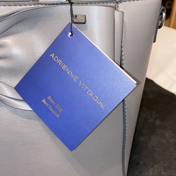 Purse with bow design on front. Brand new with tag. Gray purse. - Picture 7 of 16